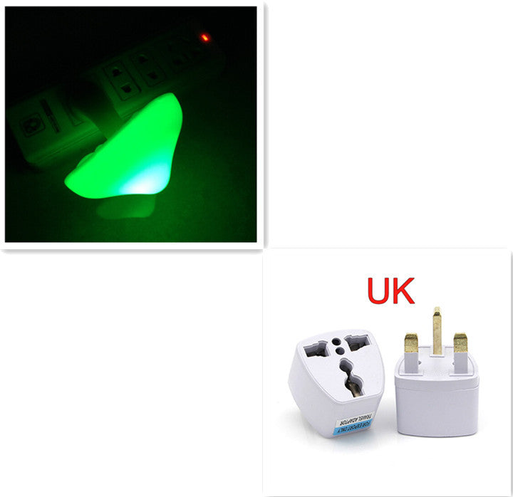 Travel adapter with green light indicator and UK plug design on a white background